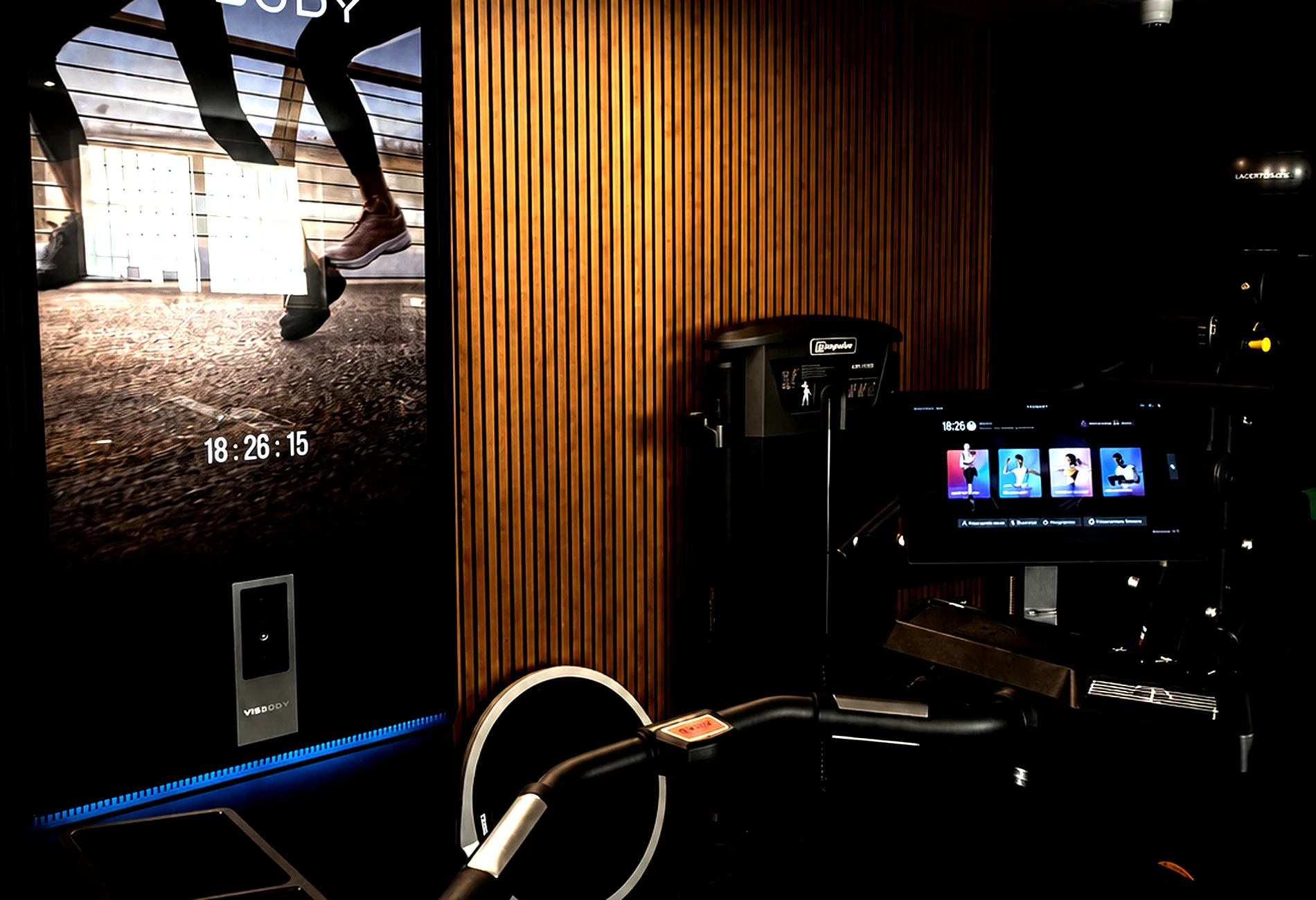 Sala training di AMW Wellness Club con boiserie in legno e attrezzature premium
